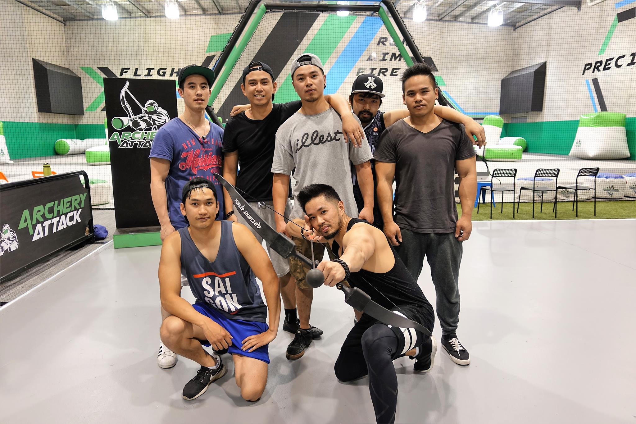 A group celebrating with bows at an Archery Attack session