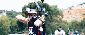 A colleague drawing a bow during a corporate Arrow Tag team-building event