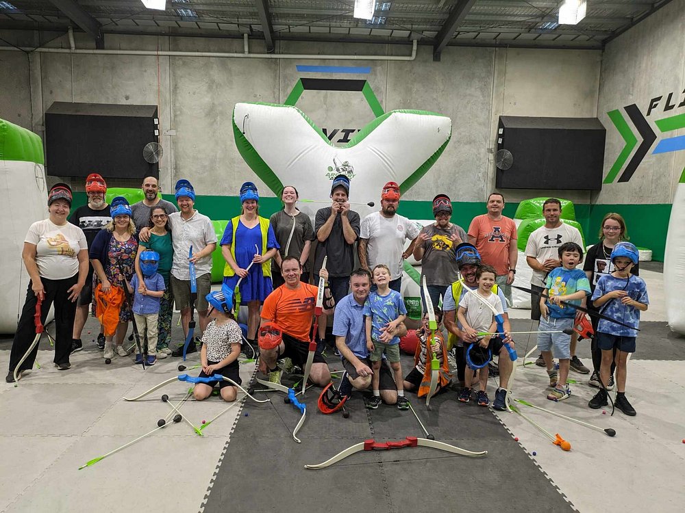 A group of all ages geared up with bows and masks at the Archery Attack arena in Reservoir, Melbourne